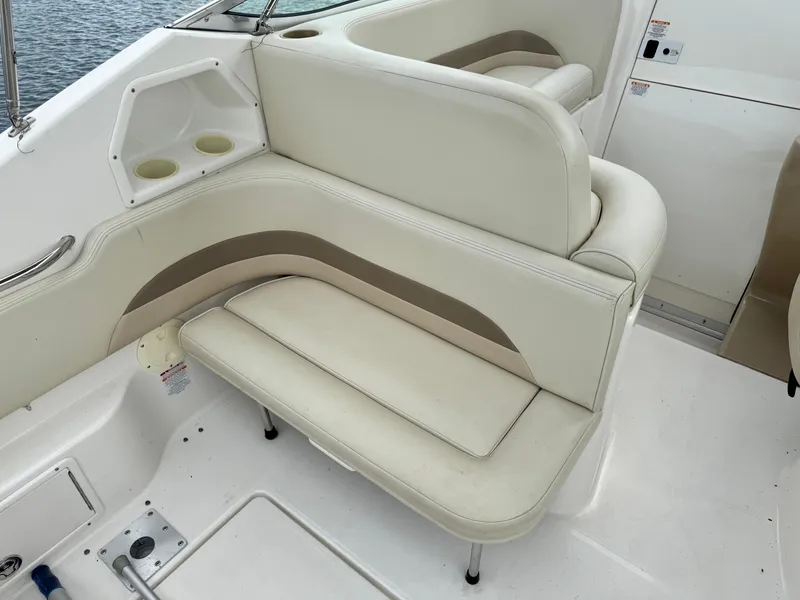 Slide: The Image of 2004 Chaparral Signature 260 boat interior seating with beige and tan upholstery. - 5