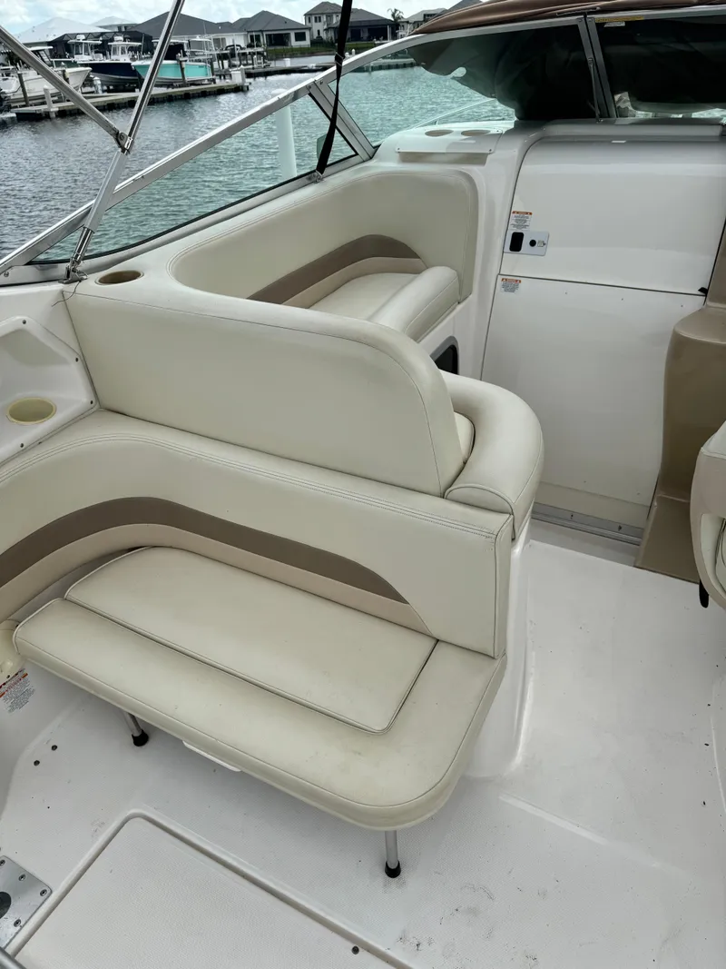Slide: The Image of 2004 Chaparral Signature 260 boat interior with white and beige seating. - 6