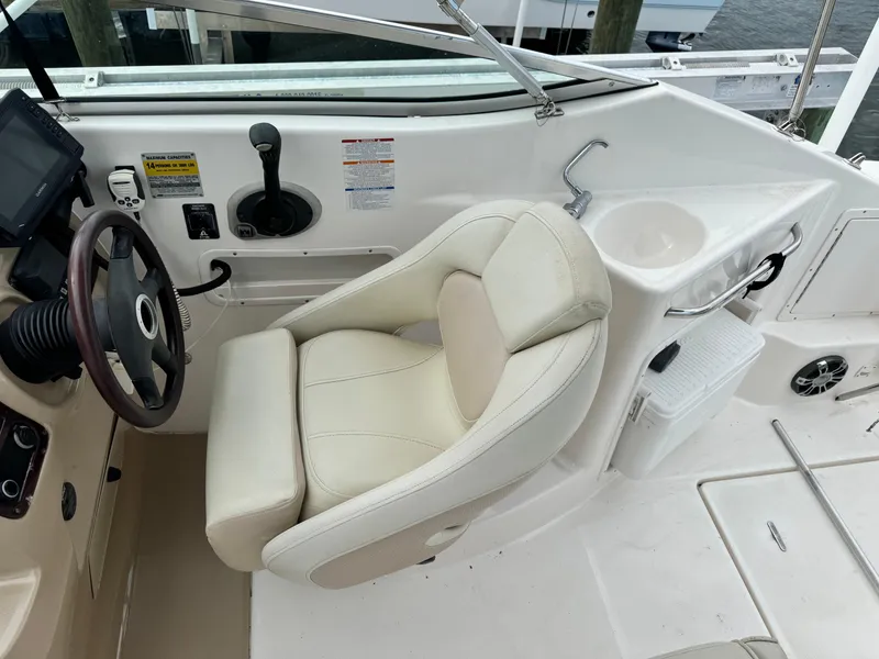 Slide: The Image of 2004 Chaparral Signature 260 boat helm with captain's chair and control panel. - 9