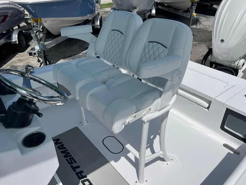 Slide: The Image of 2024 Sportsman Masters 247OE Bay Boat with dual captain's chairs and steering console. - 11