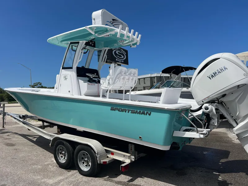 Slide: The Image of 2024 Sportsman Masters 247OE Bay Boat on trailer with Yamaha outboard motor. - 2