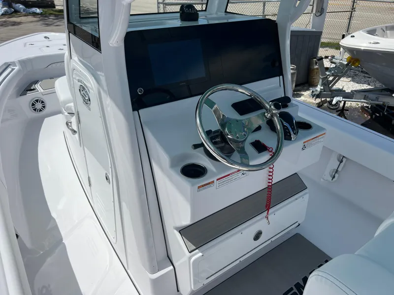 Slide: The Image of 2024 Sportsman Masters 247OE Bay Boat console and steering wheel. - 6