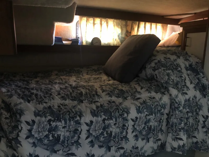 Slide: The Image of Cozy sleeping area in 1983 Carver 32 Aft Cabin with floral bedding. - 12
