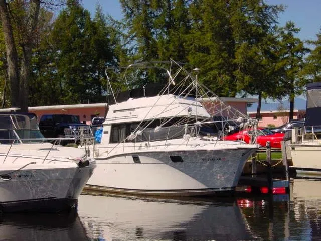 Slide: The Image of 1983 Carver 32 Aft Cabin boat docked at a marina. - 14