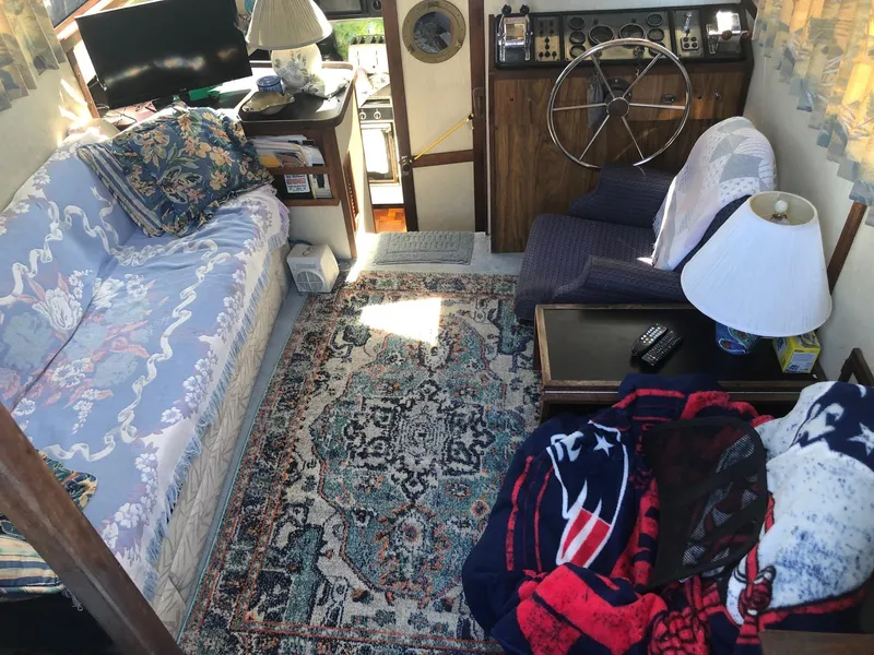 Slide: The Image of Interior of 1983 Carver 32 Aft Cabin with cozy seating and nautical decor. - 4