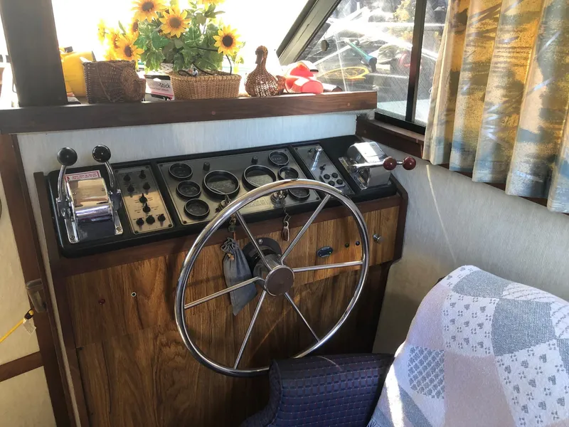 Slide: The Image of 1983 Carver 32 Aft Cabin helm with steering wheel and control panel. - 5