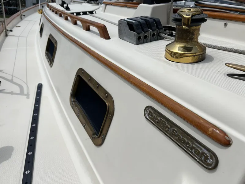 Slide: The Image of Close-up of 1994 Pacific Seacraft 34 sailboat deck with winch and wooden trim. - 11