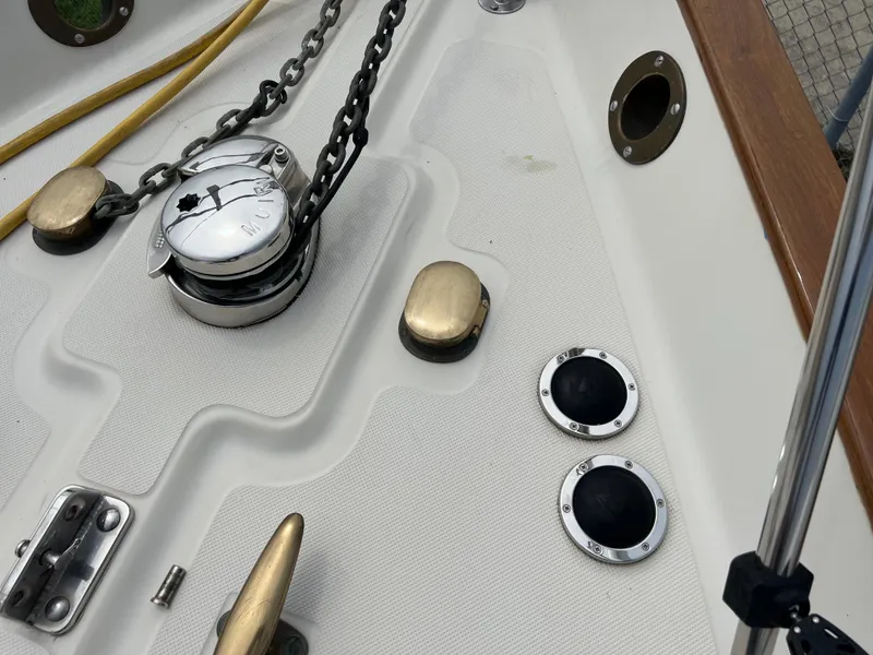 Slide: The Image of Deck of 1994 Pacific Seacraft 34 sailboat with anchor chain and deck fittings. - 16