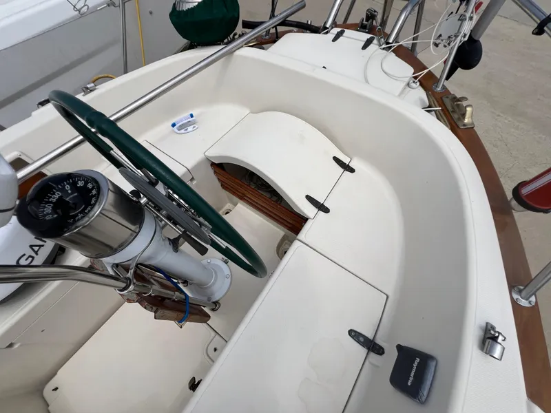 Slide: The Image of Cockpit of 1994 Pacific Seacraft 34 sailboat with green wheel and navigation instruments. - 19
