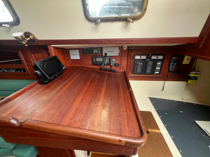 Slide: The Image of Navigation station of a 1994 Pacific Seacraft 34 sailboat with control panels and electronics. - 40