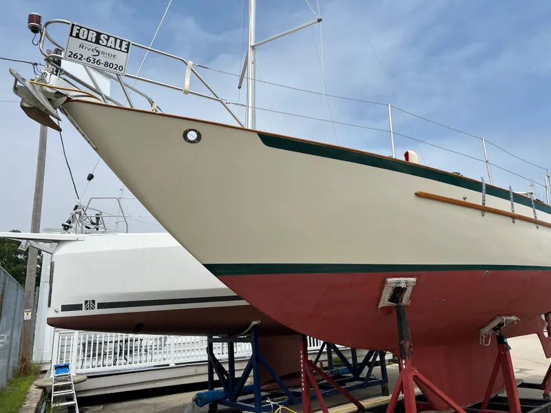 Slide: The Image of 1994 Pacific Seacraft 34 sailboat for sale, docked on land. - 7