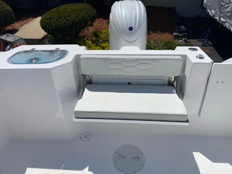 Slide: The Image of 2024 Aquasport 2200 Dual Console boat with foldable seating and outboard motor. - 3