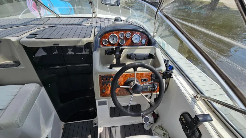 Slide: The Image of 1998 Bayliner 2855 Ciera boat cockpit with steering wheel and instrument panel. - 12
