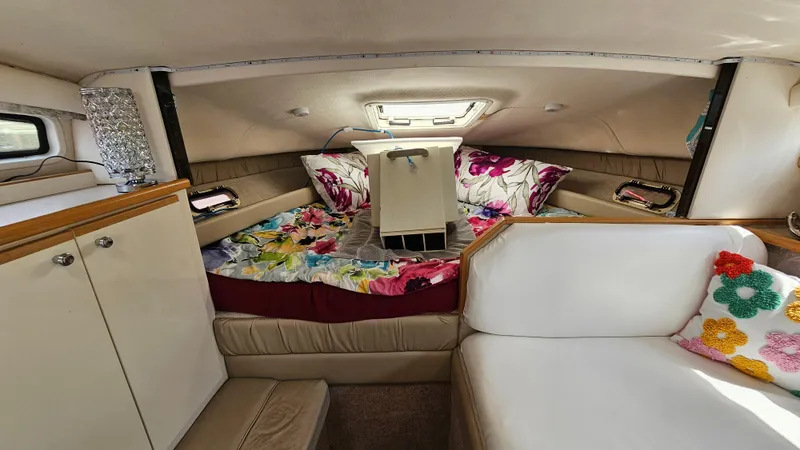 Slide: The Image of 1998 Bayliner 2855 Ciera cabin interior with floral bedding and white seating. - 15
