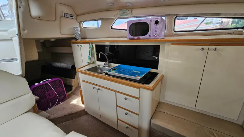 Slide: The Image of 1998 Bayliner 2855 Ciera cabin interior with kitchenette and seating area. - 17