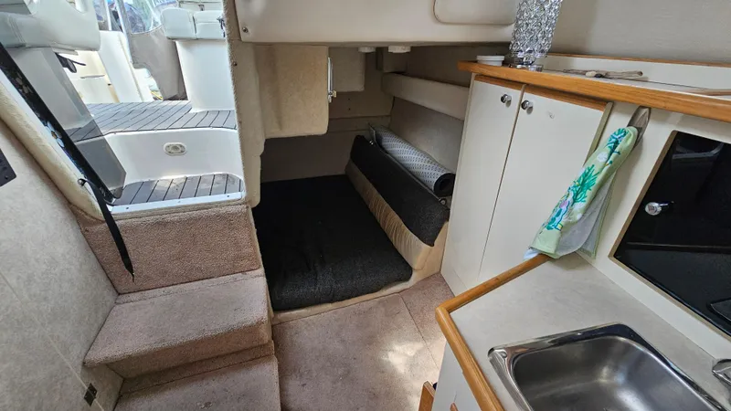 Slide: The Image of 1998 Bayliner 2855 Ciera interior cabin with kitchenette and sleeping area. - 18