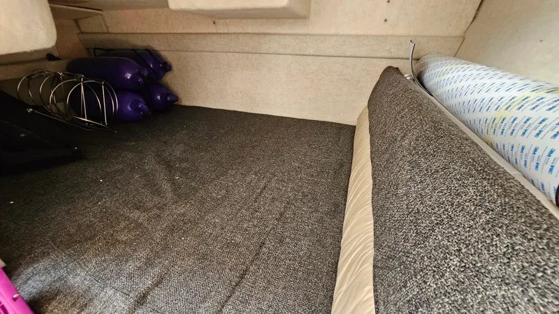 Slide: The Image of Interior cabin of a 1998 Bayliner 2855 Ciera boat with carpeted flooring. - 19