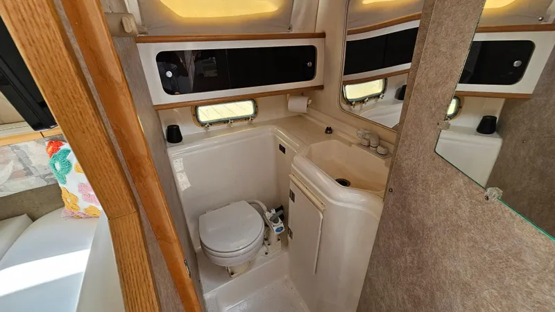 Slide: The Image of 1998 Bayliner 2855 Ciera boat bathroom with toilet, sink, and mirror. - 20