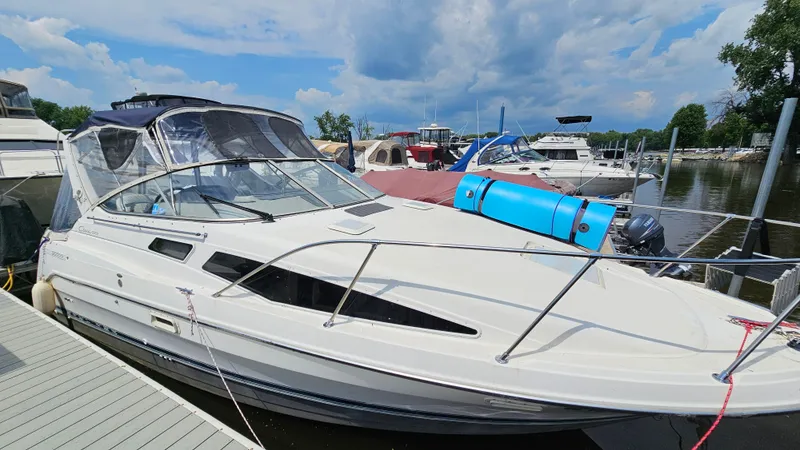 Slide: The Image of 1998 Bayliner 2855 Ciera docked at a marina on a sunny day. - 3