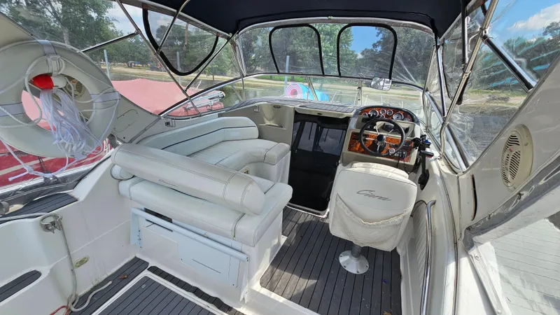 Slide: The Image of 1998 Bayliner 2855 Ciera boat interior with white seating and steering console. - 5