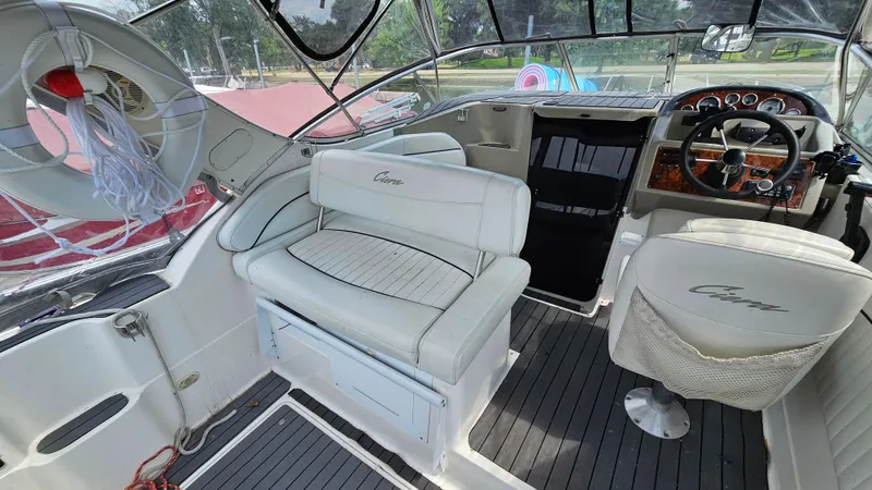 Slide: The Image of 1998 Bayliner 2855 Ciera boat interior with white seating and steering console. - 6