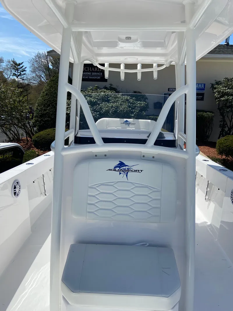 Slide: The Image of 2024 Aquasport 2400CS boat interior with seating and console. - 5