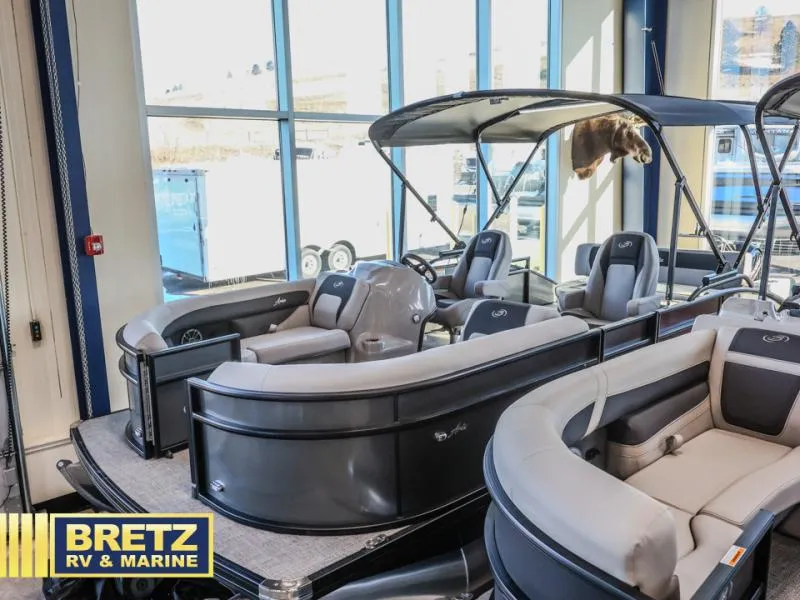 Slide: The Image of 2025 Aria A22CC pontoon boat displayed at Bretz RV & Marine showroom. - 4
