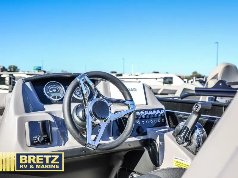 Slide: The Image of Aria Ultra-Lounge A22UC 2025 boat dashboard with steering wheel and controls. - 10