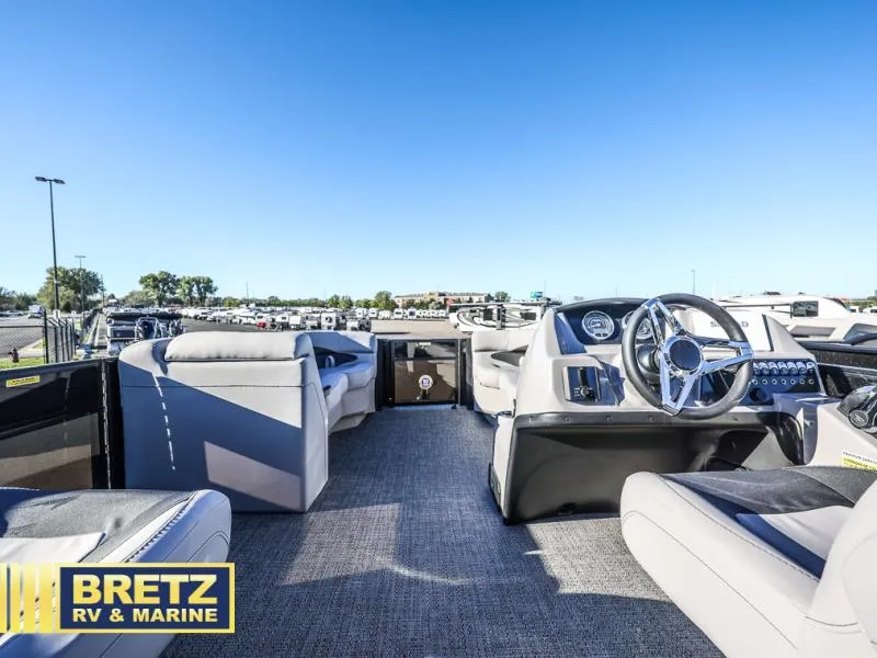 Slide: The Image of 2025 Aria Ultra-Lounge A22UC boat interior with modern seating and steering console. - 18