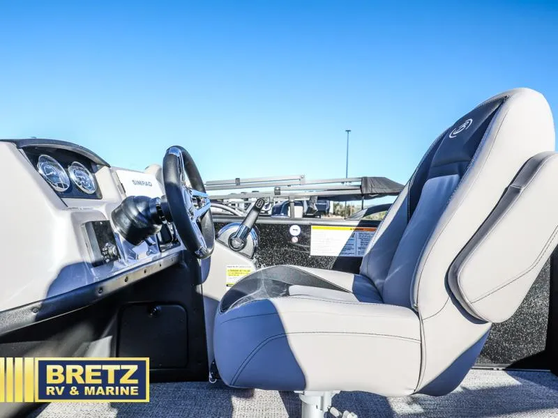 Slide: The Image of Aria Ultra-Lounge A22UC 2025 boat interior with steering wheel and captain's chair. - 9