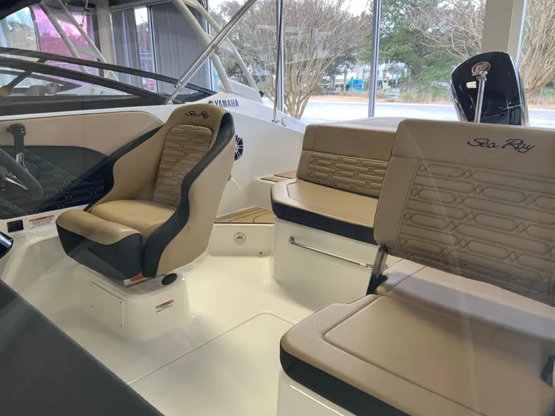 Slide: The Image of 2025 Sea Ray SPX 190 OB boat interior with beige seating and modern design. - 2