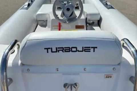 Slide: The Image of 2011 Williams Jet Tenders Turbojet 325, white interior, steering wheel, and Turbojet branding. - 12