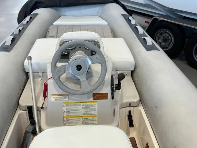Slide: The Image of 2011 Williams Jet Tenders Turbojet 325 interior with steering wheel and controls. - 2