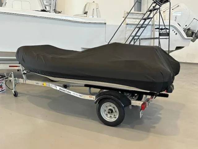 Slide: The Image of 2011 Williams Jet Tenders Turbojet 325 covered on a trailer in a garage. - 5