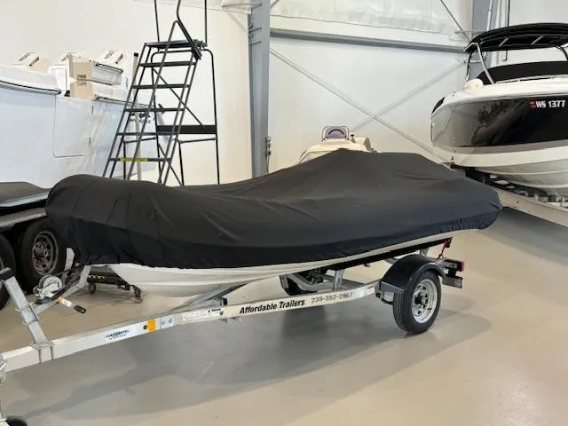 Slide: The Image of 2011 Williams Jet Tenders Turbojet 325 covered on a trailer in a storage facility. - 6