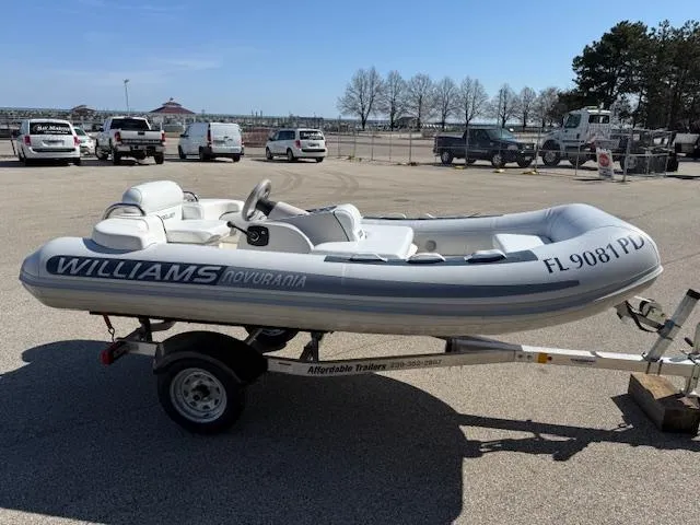 Slide: The Image of 2011 Williams Jet Tenders Turbojet 325 on trailer in parking lot. - 7