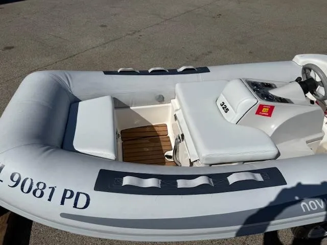 Slide: The Image of 2011 Williams Jet Tenders Turbojet 325 inflatable boat with white seating and control console. - 9