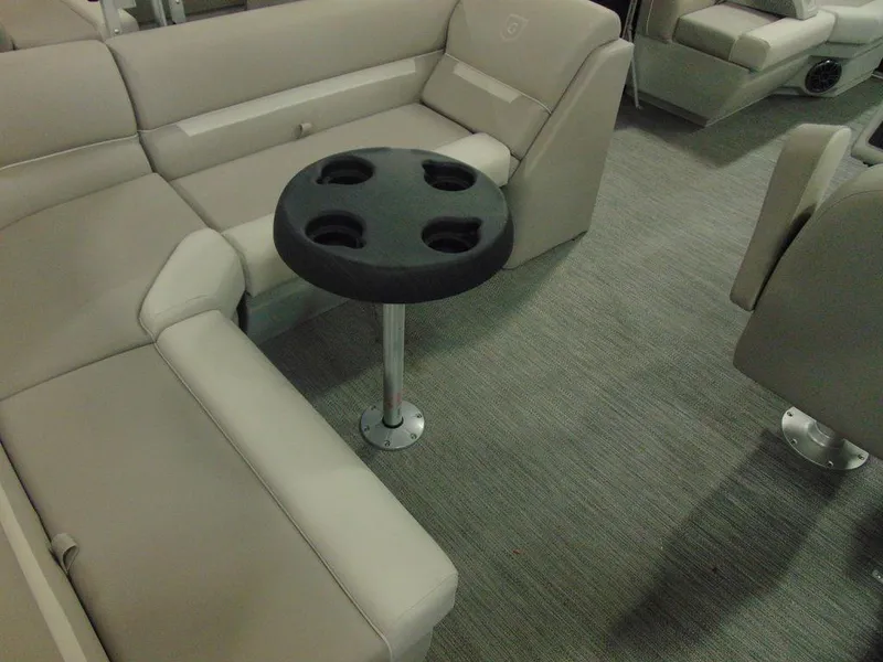 Slide: The Image of 2024 Godfrey Xperience 1880 FX 25 in. Package interior with beige seating and cup holder table. - 11