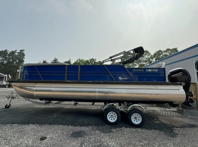 Slide: The Image of 2024 Massimo Marine P24-Limited Lounge Tritoon on trailer, side view. - 10