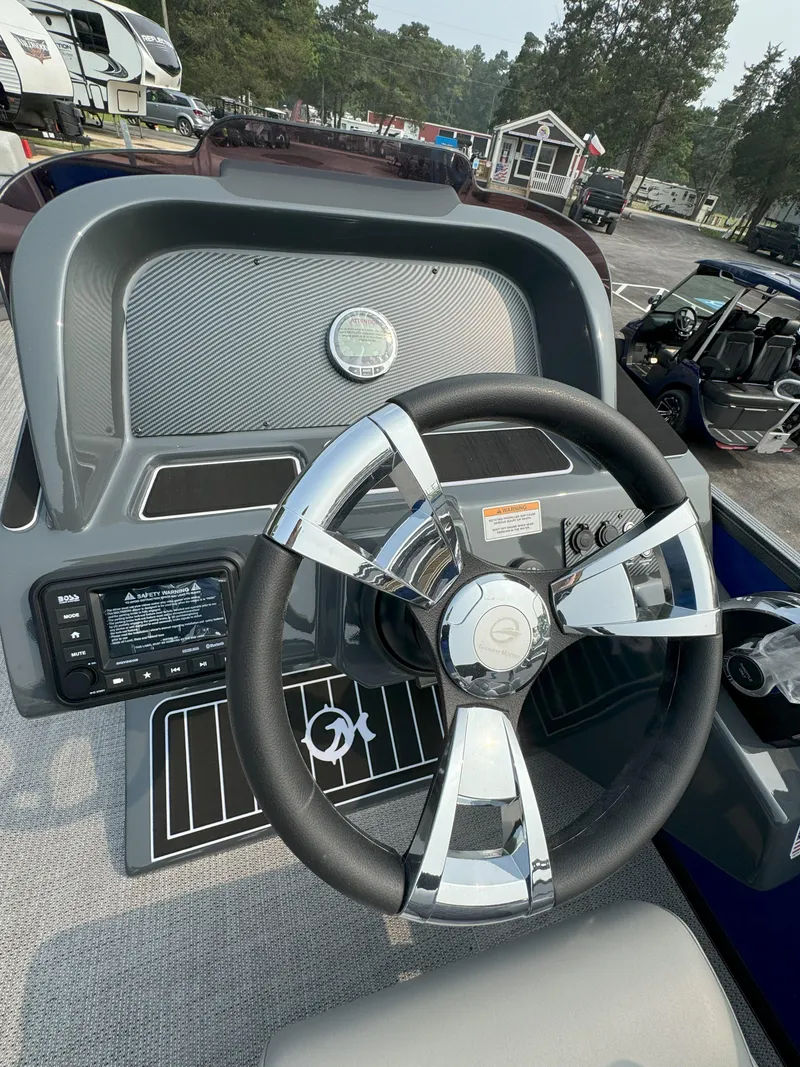 Slide: The Image of 2024 Massimo Marine P24-Limited Lounge Tritoon steering console with modern controls. - 5