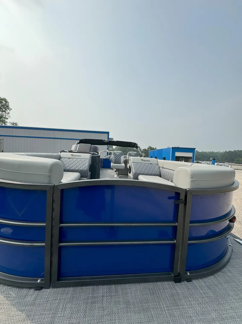 Slide: The Image of 2024 Massimo Marine P24-Limited Lounge Tritoon with blue exterior and spacious seating. - 8