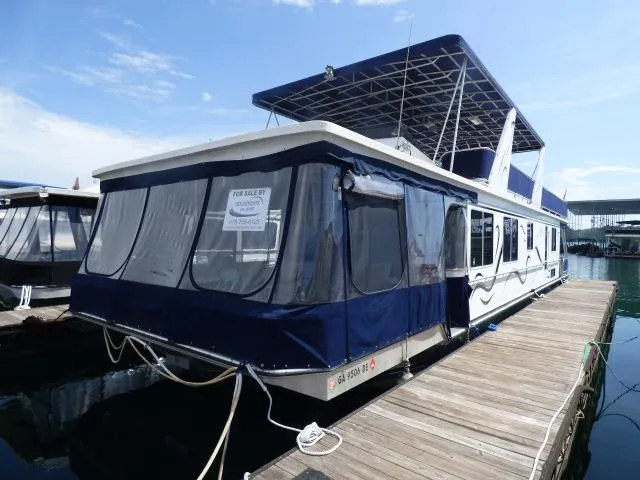 The Image of 2003 Sunstar 16x65 houseboat docked, for sale sign visible. - 0