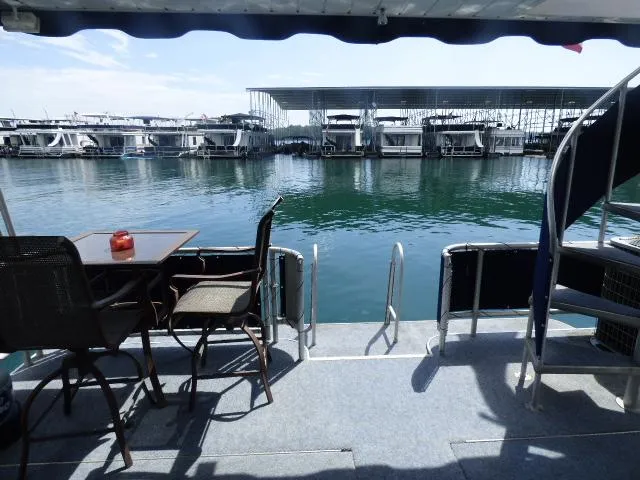 Slide: The Image of View from the deck of a 2003 Sunstar 16x65 houseboat at a marina. - 10