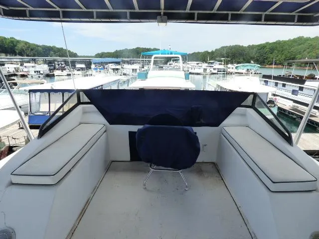 Slide: The Image of Upper deck view of a 2003 Sunstar 16x65 houseboat docked at a marina. - 12