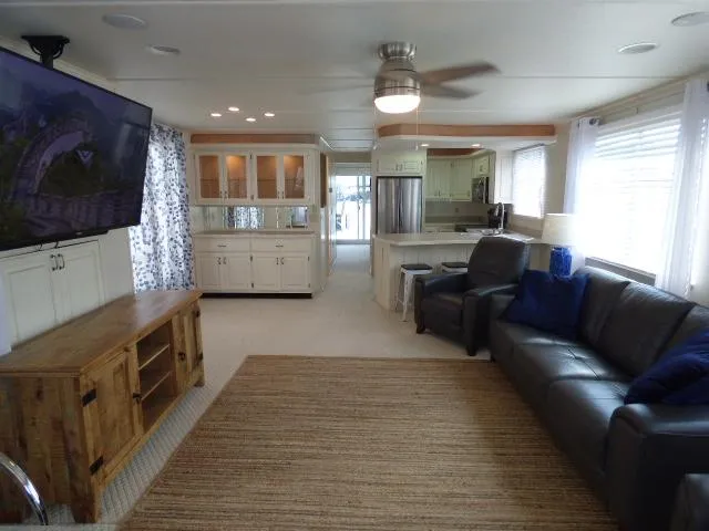 Slide: The Image of Luxurious Sunstar 16x65 houseboat interior with modern kitchen, cozy seating, and elegant dining area. - 2