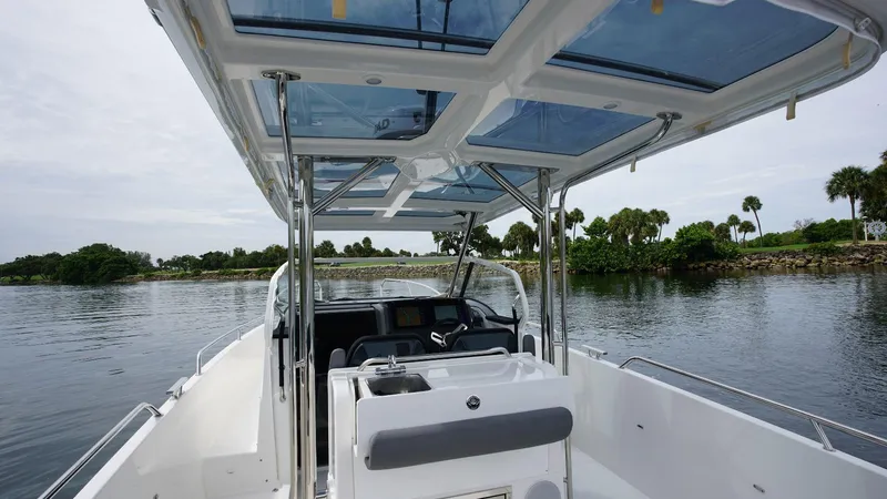 Slide: The Image of 2024 Nimbus Tender 9 #143 boat interior with open water and lush greenery. - 7