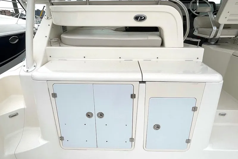 Slide: The Image of 2009 Pursuit OS 375 Offshore boat storage compartments and seating area. - 10