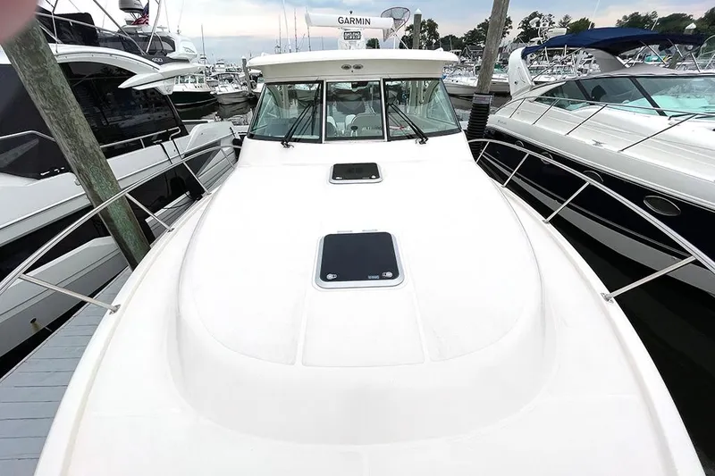 Slide: The Image of 2009 Pursuit OS 375 Offshore boat docked at a marina. - 22