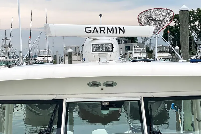 Slide: The Image of 2009 Pursuit OS 375 Offshore boat with Garmin radar at marina. - 23