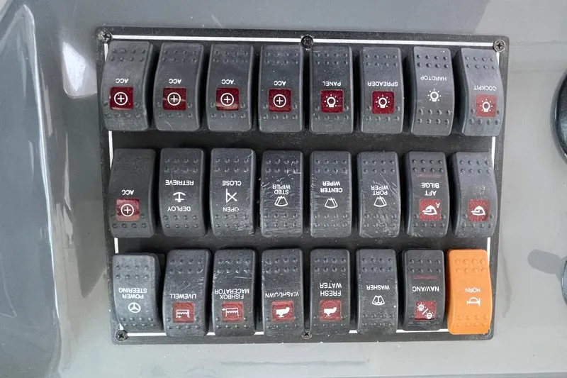 Slide: The Image of Control panel switches on a 2009 Pursuit OS 375 Offshore boat. - 3